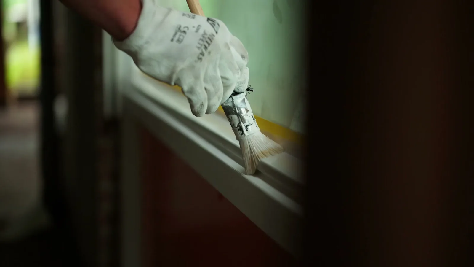 Kwast op een kozijn, detail van het lakwerk